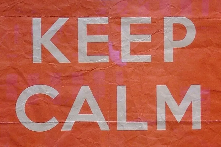 The words Keep Calm in white capitals on the creased red paper of the 1939 poster