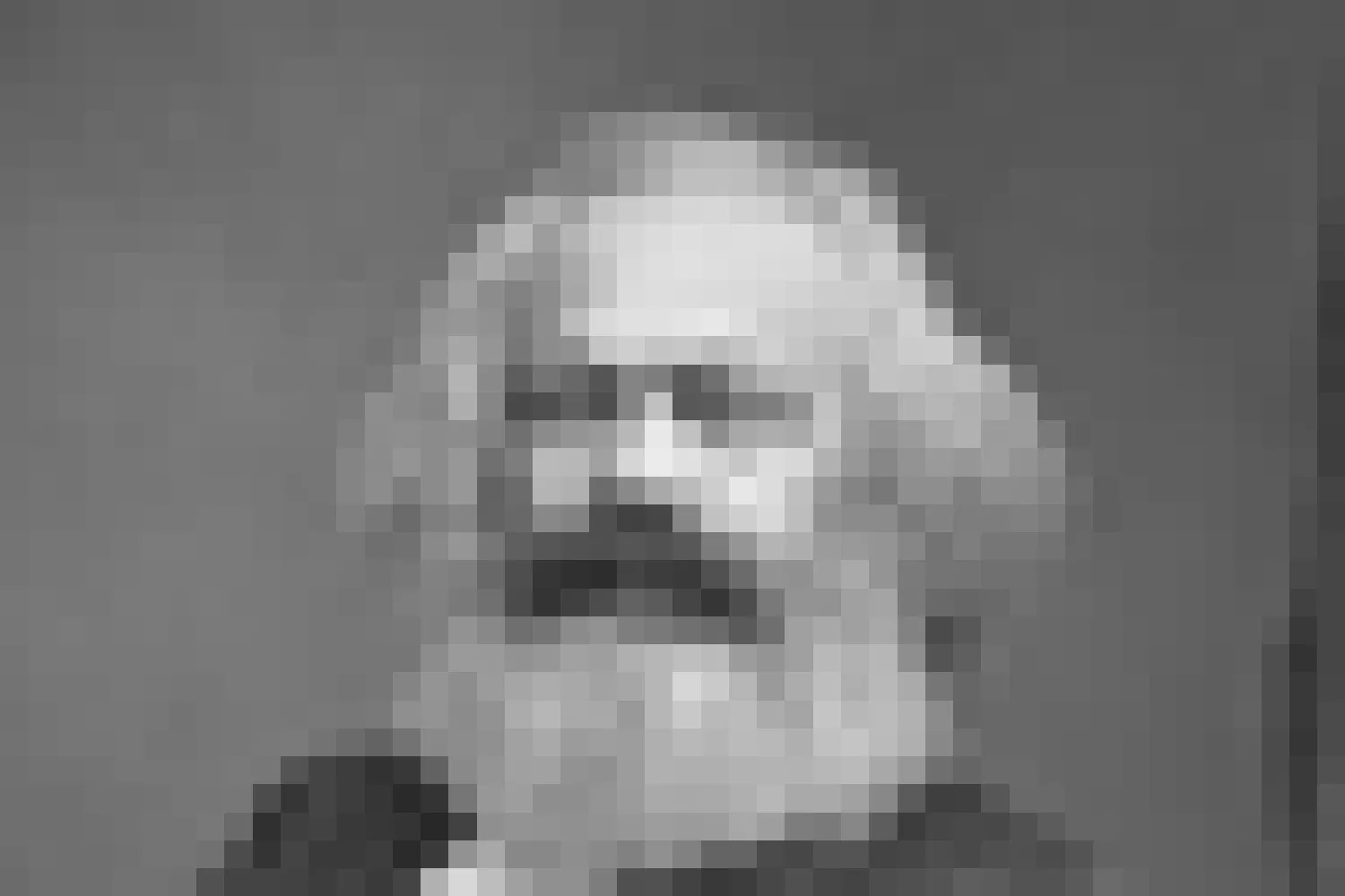 A heavily pixelated black-and-white portrait of Karl Marx